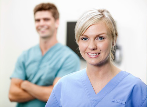 Young Female Vet In Scrubs Smiling